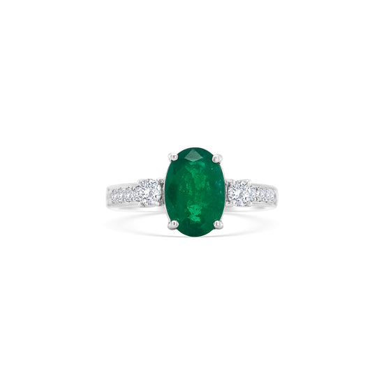 Oval emerald ring, emerald trilogy ring, emerald and diamond ring, diamond trilogy ring, diamond and emerald jewelry, fine jewelry, elegant ring, gemstone ring, luxury jewelry, three-stone ring, green gemstone ring."