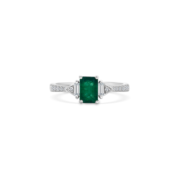 A luxurious emerald and diamond trilogy ring, featuring exquisite emerald gemstones surrounded by sparkling diamonds. This stunning ring boasts a timeless design, perfect for adding elegance and sophistication to any ensemble.