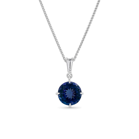 A stunning round solitaire Tanzanite & Diamond Pendant, perfect for adding elegance to any outfit, featuring a captivating tanzanite stone surrounded by dazzling diamonds, ideal for a sophisticated evening look, crafted with exquisite detail and craftsmanship, showcasing the mesmerizing beauty of Tanzanite and the brilliance of diamonds.