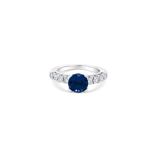 A stunning round Tanzanite and diamond ring, featuring a vibrant Tanzanite centerpiece surrounded by sparkling diamonds, set in luxurious white gold. Perfect for adding elegance and sophistication to any ensemble.