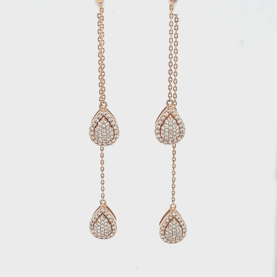 Pear Shape Illusion Drop Diamond Earrings, elegant jewelry, diamond-studded earrings, sophisticated design, sparkling pear-shaped drops, eye-catching illusion setting, luxurious accessory, glamorous style, exquisite craftsmanship, radiant pear diamonds, statement earrings, dazzling fashion piece.