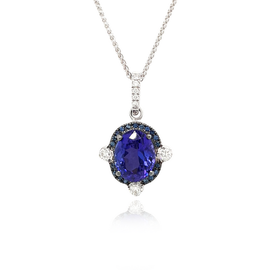 A stunning Oval Tanzanite pendant surrounded by a dazzling halo of diamonds. The rich, violet hues of the Tanzanite gemstone are accentuated by the sparkling brilliance of the surrounding diamonds. This elegant pendant is a timeless piece that effortlessly combines the allure of the oval-shaped Tanzanite with the glamour of a diamond halo. Perfect for adding a touch of sophistication to any ensemble.