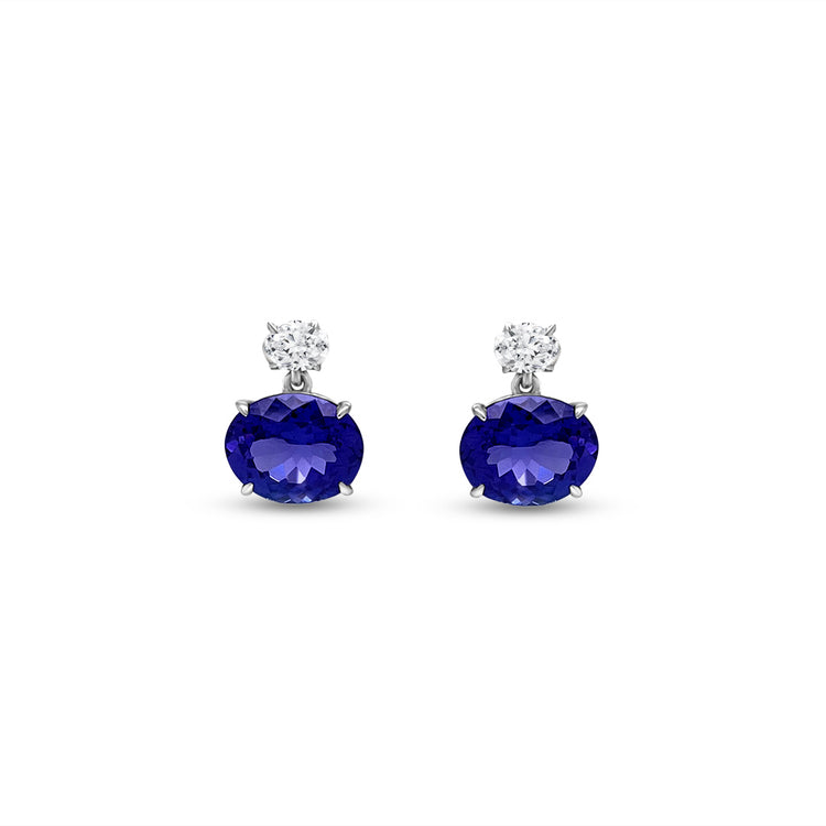 Main Image: "7.10ct Oval Tanzanite & Diamond Dangle Earrings" Tanzanite Detail: "Captivating Oval Tanzanite Gemstones" Diamond Halo: "Halo of Sparkling Diamonds Surrounding Tanzanite" Earrings in Motion: "Dangle Earrings with Movement and Radiance" Different Open Liners: "Earrings with Customizable Open Liner Options" Timeless Elegance: "Elegant Design of Oval Tanzanite & Diamond Earrings"