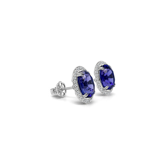 Main Image: "7.70ct Oval Tanzanite & Diamond Halo Stud Earrings" Tanzanite Detail: "Captivating Oval Tanzanite Gems" Diamond Halo: "Sparkling Diamond Halo Accentuating Tanzanite" Earring Profile: "Oval Tanzanite & Diamond Halo Stud Earrings Profile" Customizable Liners: "Earrings with Different Open Liners for Personalization" Stylish Presentation: "Elegant Presentation of Oval Tanzanite & Diamond Earrings"