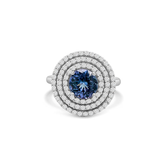 Round tanzanite ring," "Diamond triple halo ring," "Tanzanite and diamond ring," "Halo engagement ring," "Gemstone halo ring," "Luxury jewelry," "Fine jewelry," "Statement ring," "Fashion ring," "Precious gemstone ring."