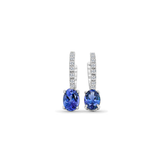 Oval Tanzanite and Diamond Dangle Earrings, Elegant Gemstone Jewelry, Lavish Tanzanite Drop Earrings, Sparkling Diamond Accents, Statement Dangling Gemstone Earrings, Exquisite Oval Tanzanite Design, Luxurious Diamond Embellishments, Fine Jewelry for Special Occasions, Sophisticated Gemstone Accessories, Stunning Tanzanite and Diamond Combination.