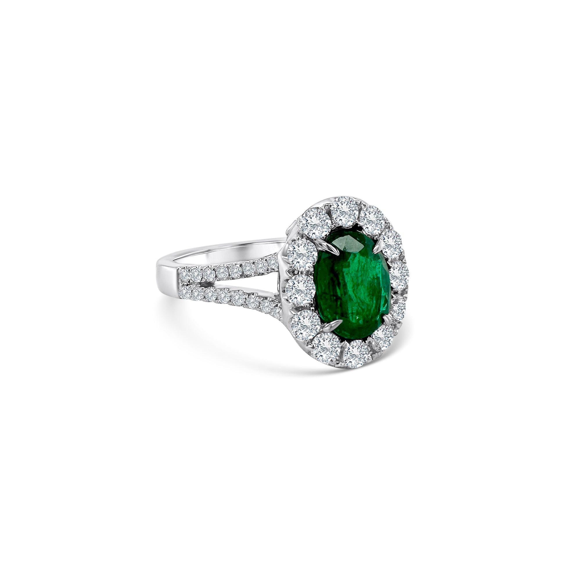  Oval emerald and diamond halo ring, showcasing a vibrant green emerald surrounded by sparkling diamonds, perfect for adding elegance and sophistication to any ensemble.