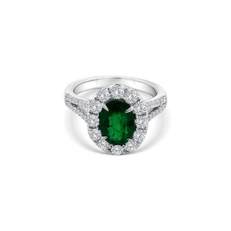  Oval emerald and diamond halo ring, showcasing a vibrant green emerald surrounded by sparkling diamonds, perfect for adding elegance and sophistication to any ensemble.