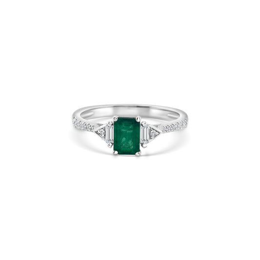 A luxurious emerald and diamond trilogy ring, featuring exquisite emerald gemstones surrounded by sparkling diamonds. This stunning ring boasts a timeless design, perfect for adding elegance and sophistication to any ensemble.