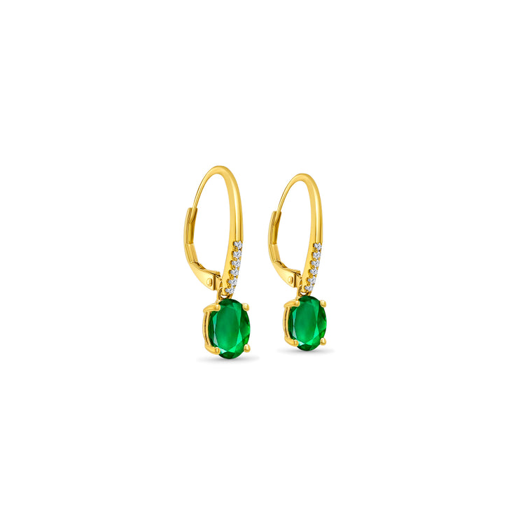 Oval emerald drop earrings, diamond-accented jewelry, elegant gemstone earrings, statement accessory, luxurious emerald jewelry, sparkling diamond earrings, exquisite gemstone drops, fine jewelry pieces, glamorous emerald and diamond combination, sophisticated earrings.