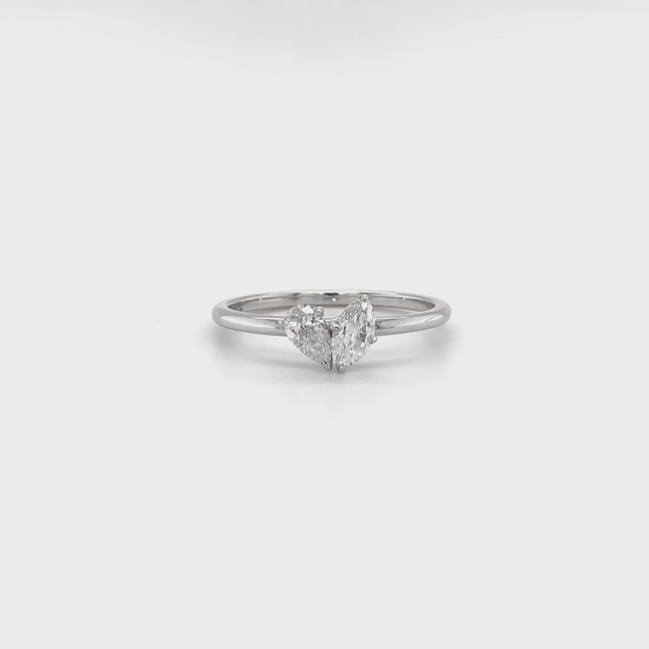 "Two stone diamond ring, Pear cut diamond ring, Marquise cut diamond ring, Elegant diamond ring, Diamond engagement ring, Sparkling diamond ring, Sophisticated diamond ring, Diamond jewelry, Fine jewelry, Luxury ring."