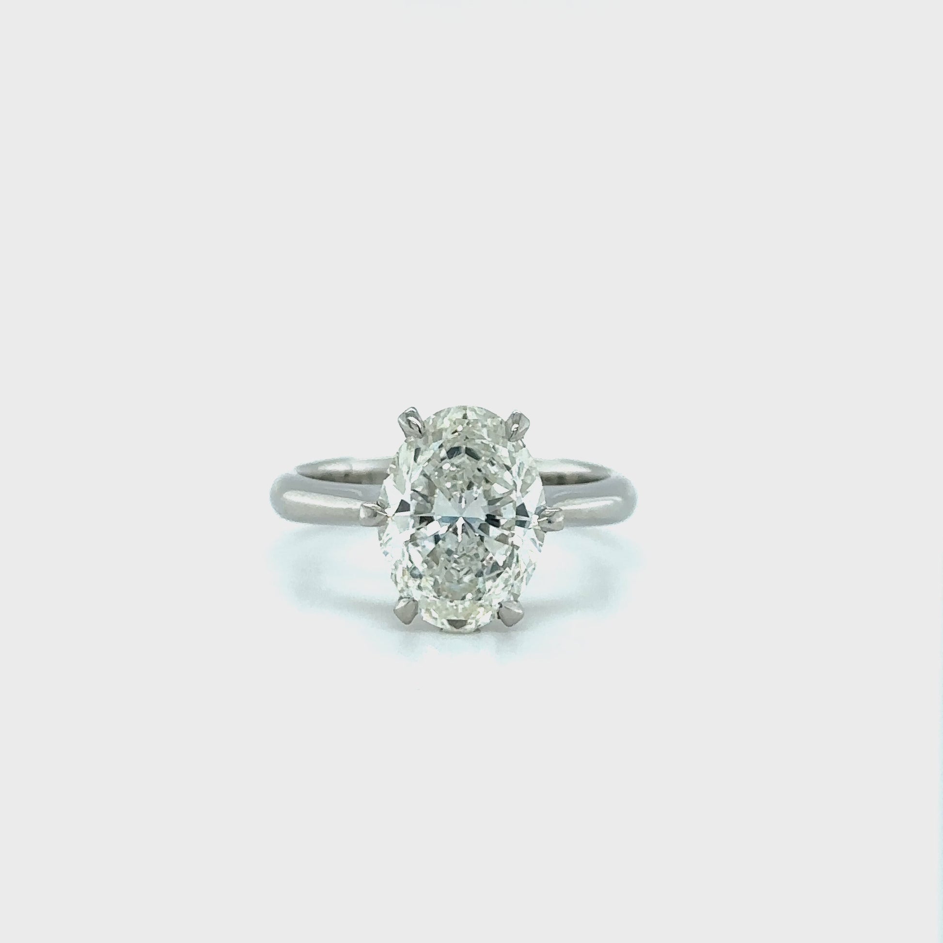 A, shimmering, oval, solitaire, diamond, ring, glitters, gracefully, on, a, finger, adorned, with, elegance, and, sophistication, perfect, for, engagements, or, special, occasions