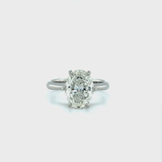 A, shimmering, oval, solitaire, diamond, ring, glitters, gracefully, on, a, finger, adorned, with, elegance, and, sophistication, perfect, for, engagements, or, special, occasions