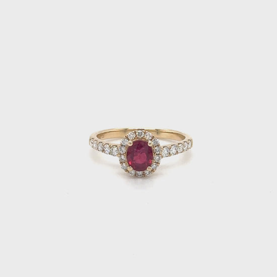 A stunning oval ruby center stone ring surrounded by a sparkling diamond halo, set in white gold, perfect for an elegant evening out or a glamorous event, jewelry that exudes luxury and sophistication, showcasing the timeless beauty of rubies and diamonds, a symbol of love, passion, and refinement.