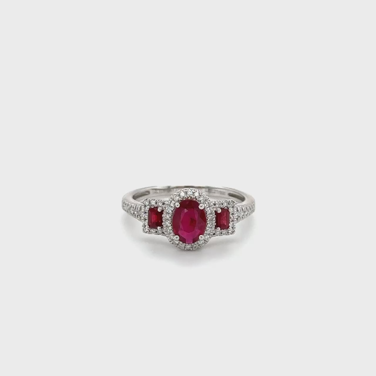 "Ruby & Diamond Trilogy Halo Ring, exquisite ruby ring, stunning diamond ring, elegant halo ring, luxurious gemstone ring, statement jewelry piece, breathtaking ruby and diamond ring, dazzling gemstone halo ring, fine jewelry masterpiece, exquisite ruby and diamond jewelry, high-quality gemstone ring"