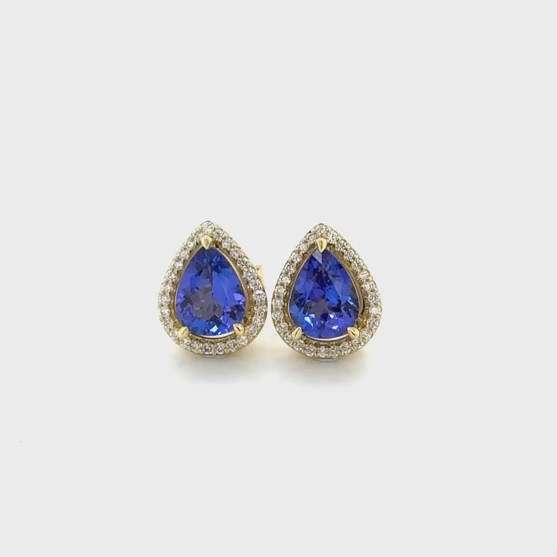 "pear-shaped tanzanite earrings, diamond halo studs, fine jewelry, gemstone studs, elegant accessories, luxury earrings, precious stones, halo setting, pear-cut gems, sparkling diamonds, glamorous earrings, statement jewelry"