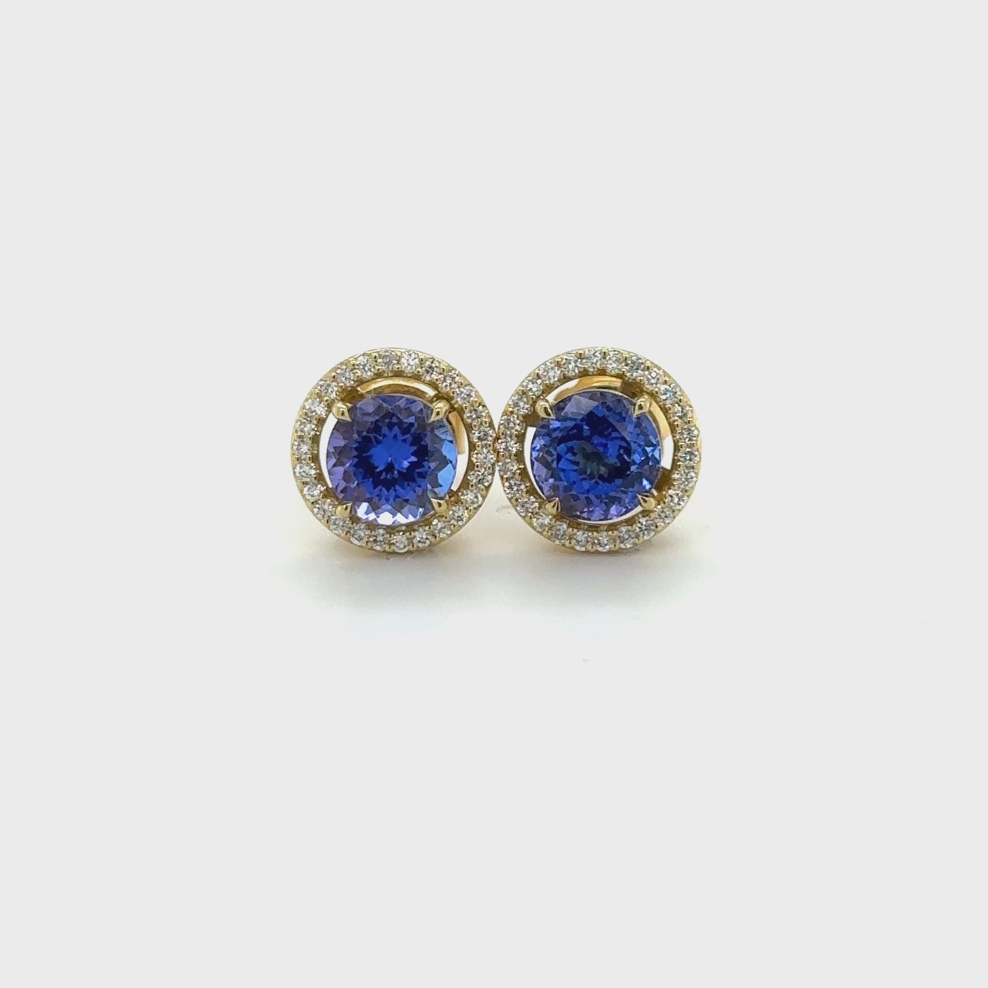 Tanzanite and Diamond Halo Stud Earrings, exquisite gemstone jewelry, elegant stud earrings, vibrant tanzanite stones, brilliant diamonds, sophisticated halo design, luxurious accessories, timeless elegance, fine craftsmanship, statement jewelry, radiant sparkle.