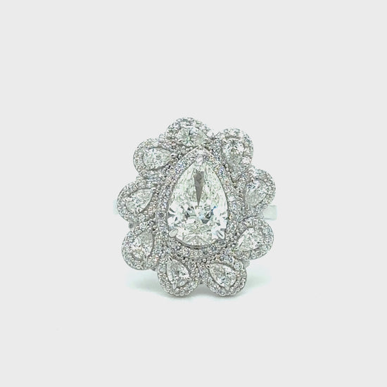 A, Multishape, Floral, Halo, Diamond, Ring, showcasing, various, shapes, including, round, pear, marquise, and, princess, cut, diamonds, set, within, a, delicate, floral, halo, design, crafted, in, luxurious, metal, for, an, exquisite, and, captivating, appearance.