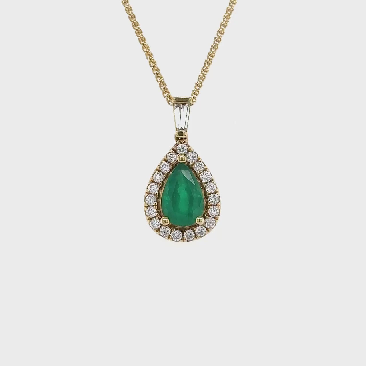 Emerald pendant, Halo diamond pendant, Pear shape jewelry, Gemstone pendant, Jewelry with diamonds, Elegant necklace, Green gemstone pendant, Luxury accessory, Statement jewelry, Sparkling pendant