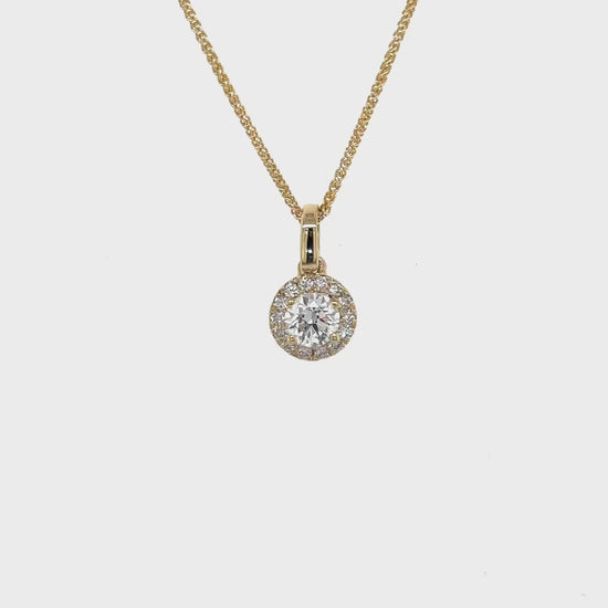 A round brilliant diamond pendant, sparkling diamond pendant, elegant halo pendant, diamond halo necklace, exquisite jewelry piece, luxurious round pendant, dazzling diamond accessory, stunning halo pendant, radiant round pendant, shimmering diamond halo pendant.