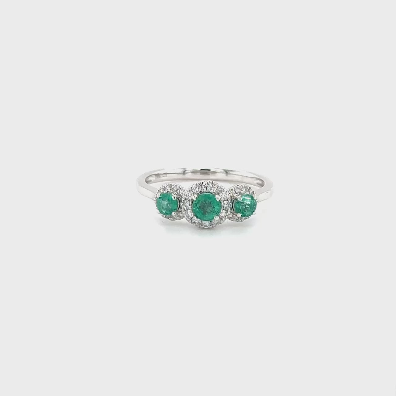A captivating Round Emerald & Diamond Halo Ring, crafted to perfection with shimmering diamonds and a brilliant emerald centerpiece, ideal for adding a touch of glamour to any ensemble
