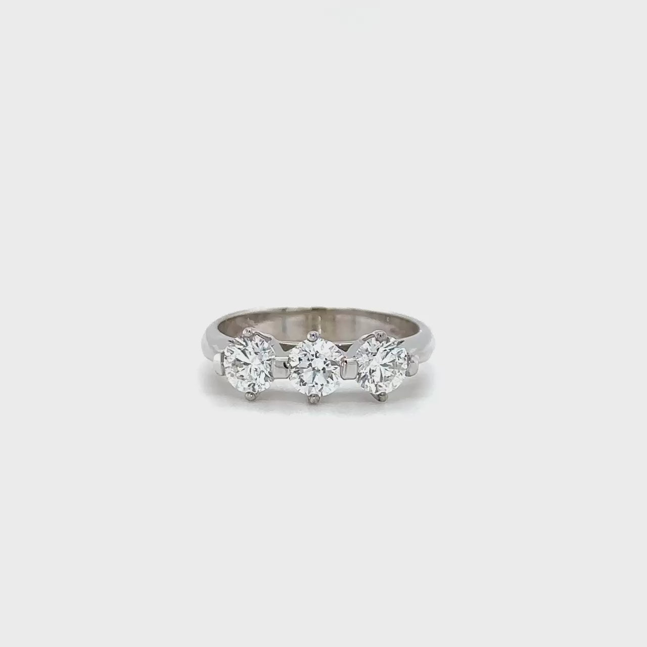 Round brilliant diamond trilogy ring, three-stone diamond ring, sparkling diamond trilogy ring, diamond anniversary ring, classic diamond trilogy ring, elegant three-stone ring, timeless diamond trilogy ring, exquisite diamond trilogy ring, stunning three-stone diamond ring, breathtaking diamond trilogy ring