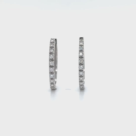 "Round Brilliant Diamond Earrings," "Huggy Earrings," "Diamond Stud Earrings," "Small Diamond Hoops," "Classic Diamond Jewelry," "Everyday Diamond Earrings," "Diamond Huggie Hoops," "Timeless Diamond Accessories."