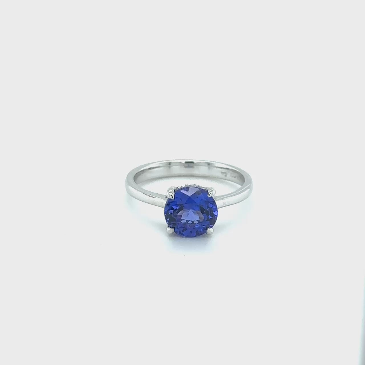 Round Solitaire Tanzanite & Diamond Ring": "A stunning round solitaire Tanzanite ring featuring a sparkling diamond accent, perfect for adding elegance and sophistication to any outfit, ideal for special occasions or everyday wear.