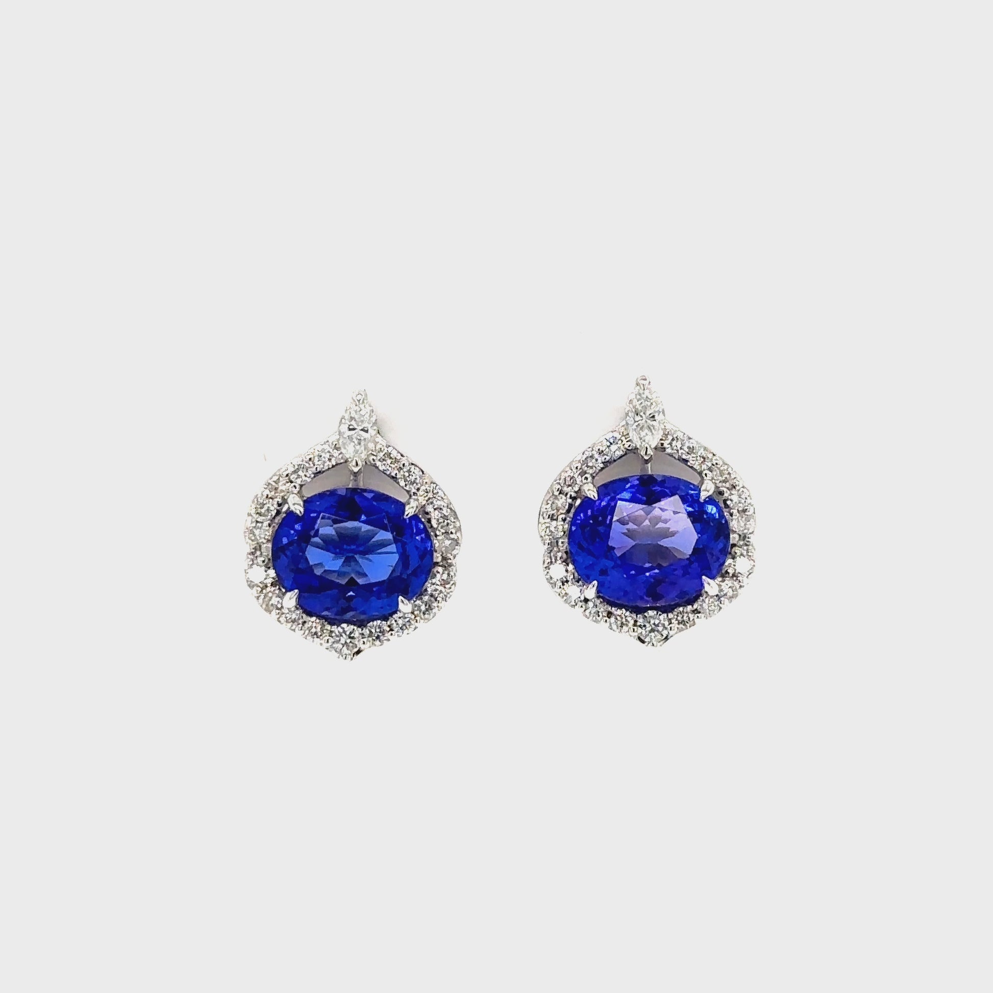  Oval Tanzanite and Diamond Halo Stud Earrings: Elegant Tanzanite studs, dazzling diamond halo, exquisite jewelry, precious gemstone earrings, sparkling gemstone studs, luxurious oval-shaped Tanzanite, radiant diamond accents, stunning halo design, sophisticated stud earrings, timeless and stylish jewelry.