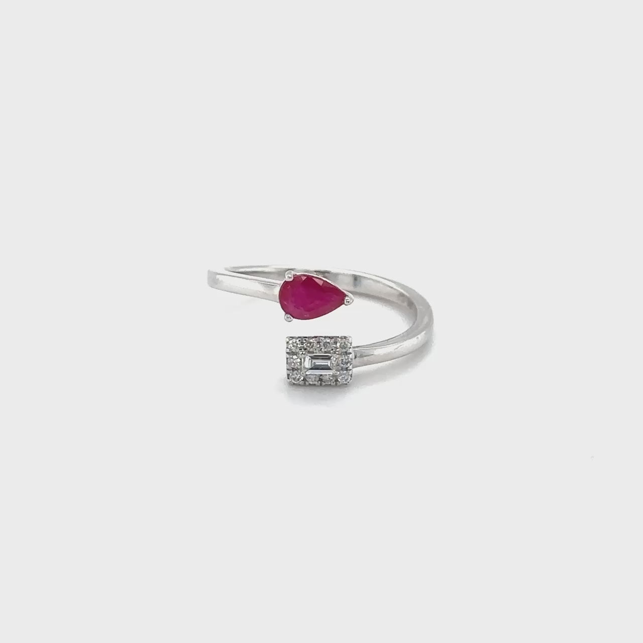 "pear shape ruby ring, diamond ring, gemstone jewelry, red gemstone ring, luxury jewelry, statement ring, precious stone ring, anniversary gift, engagement ring, fine jewelry, unique design, cocktail ring, pear cut gemstone, elegant accessory"