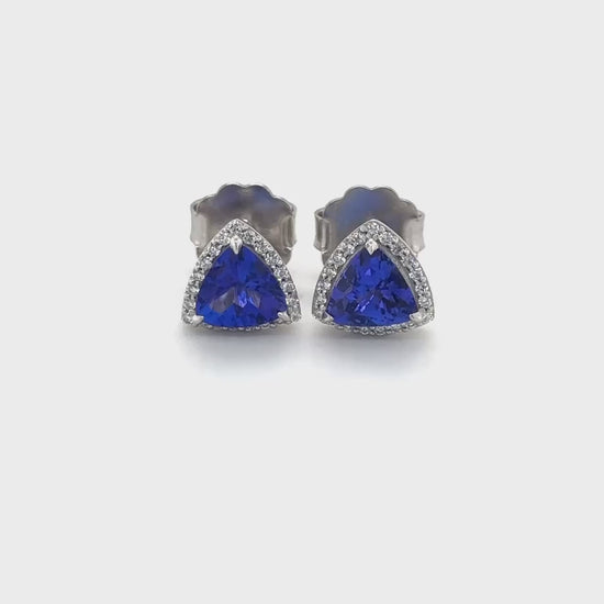 Trillion cut tanzanite earrings, halo stud earrings, trillion tanzanite studs, elegant tanzanite jewelry, luxurious halo earrings, trillion gemstone studs, exquisite tanzanite studs, stunning halo earrings.