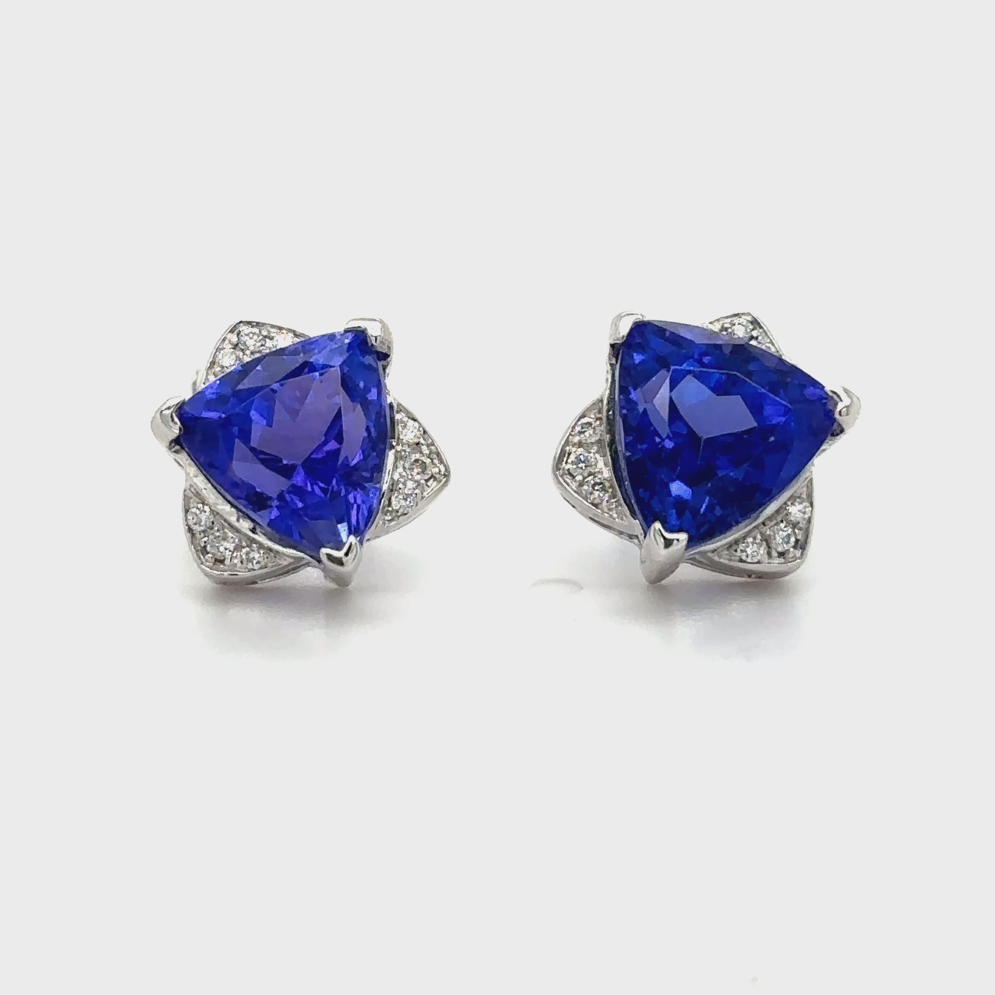 These stunning trillion cut tanzanite and diamond stud earrings are a perfect blend of vibrant color and timeless elegance. Featuring brilliant trillion-shaped tanzanite gemstones, each framed by sparkling diamond accents, these earrings exude sophistication and charm. The unique trillion cut enhances the tanzanite's vivid blue-violet hues, while the diamonds add a touch of radiant brilliance. Perfect for adding a pop of color to any outfit or as a thoughtful gift, these earrings are a dazzling expression o