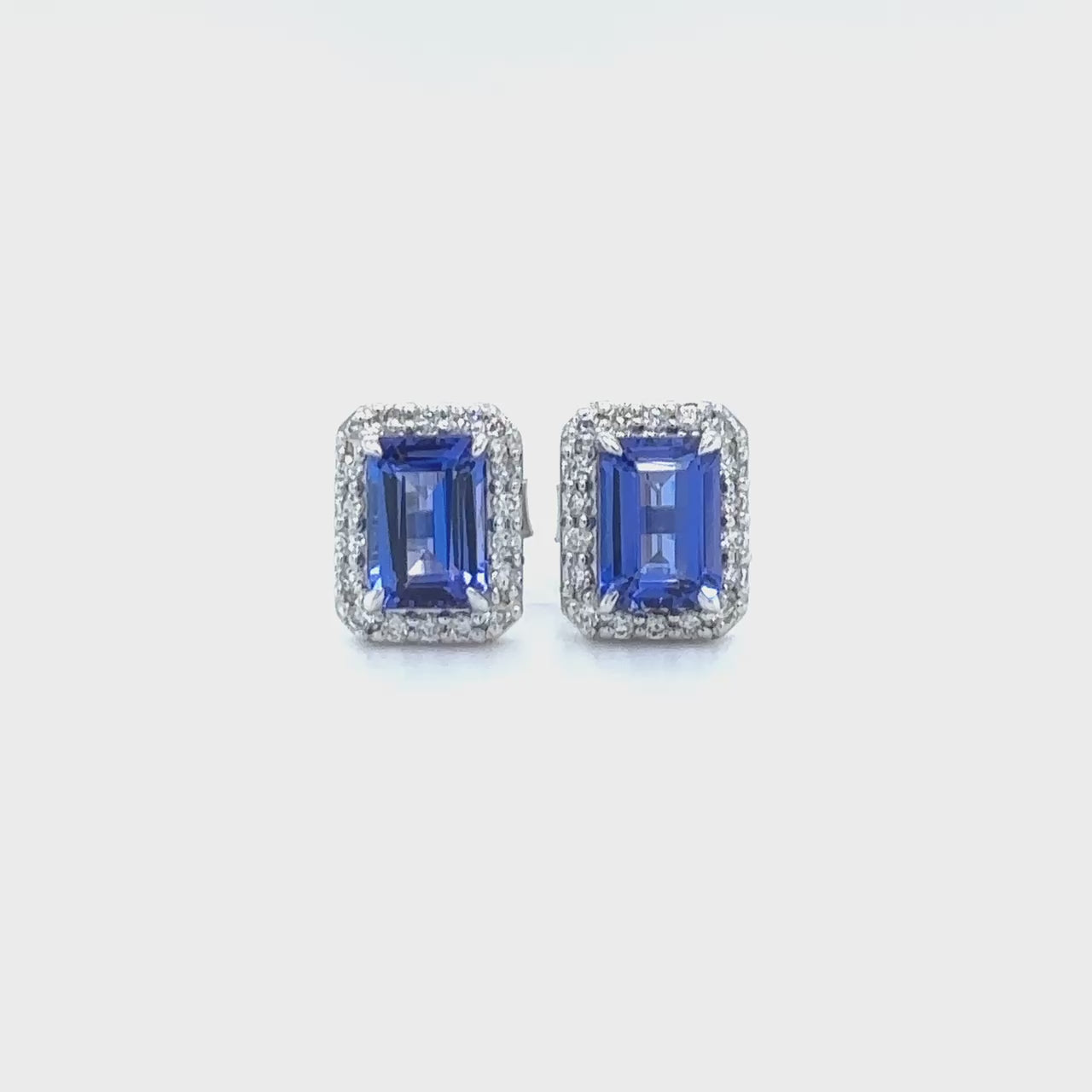 "Emerald Cut Tanzanite & Diamond Halo Stud Earrings," "Tanzanite and Diamond Stud Earrings," "Halo Stud Earrings," "Fine Jewelry," "Luxury Earrings," "Fashion Earrings," "Gemstone Jewelry," "Sparkling Tanzanite Earrings," "Statement Earrings," "Elegant Jewelry," "Special Occasion Earrings," "Tanzanite Jewelry," "Timeless Jewelry," "Handcrafted Earrings," "Unique Gemstone Studs."