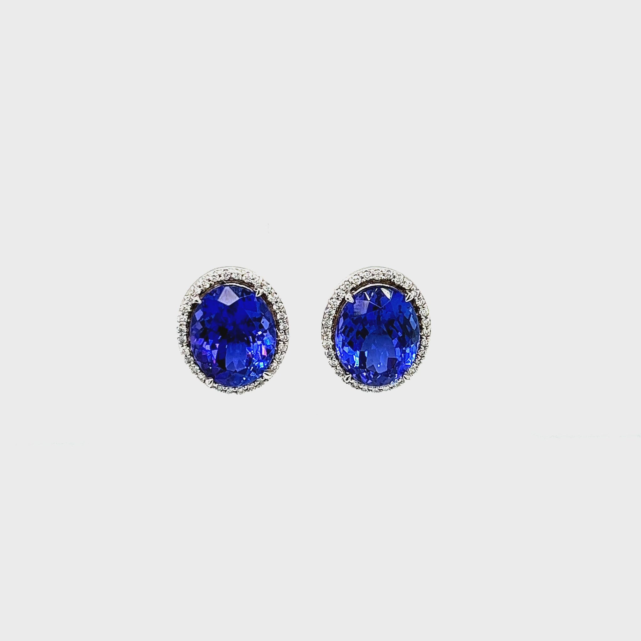 Oval tanzanite earrings Halo diamond stud earrings 10.80ct tanzanite earrings Luxury gemstone earrings Blue-violet tanzanite jewelry Exquisite diamond earrings Statement earrings for special occasions Fine jewelry with tanzanite Precious gemstone earrings Elegant and timeless earrings.