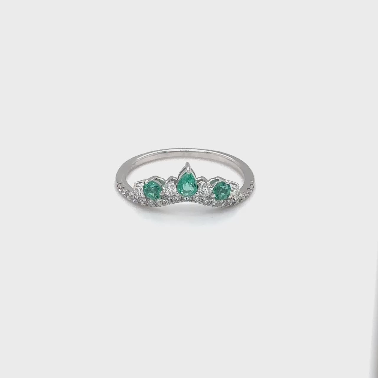 A stunning Pear & Round Emerald & Diamond Halo Ring, featuring exquisite emeralds and dazzling diamonds, perfect for special occasions or everyday elegance