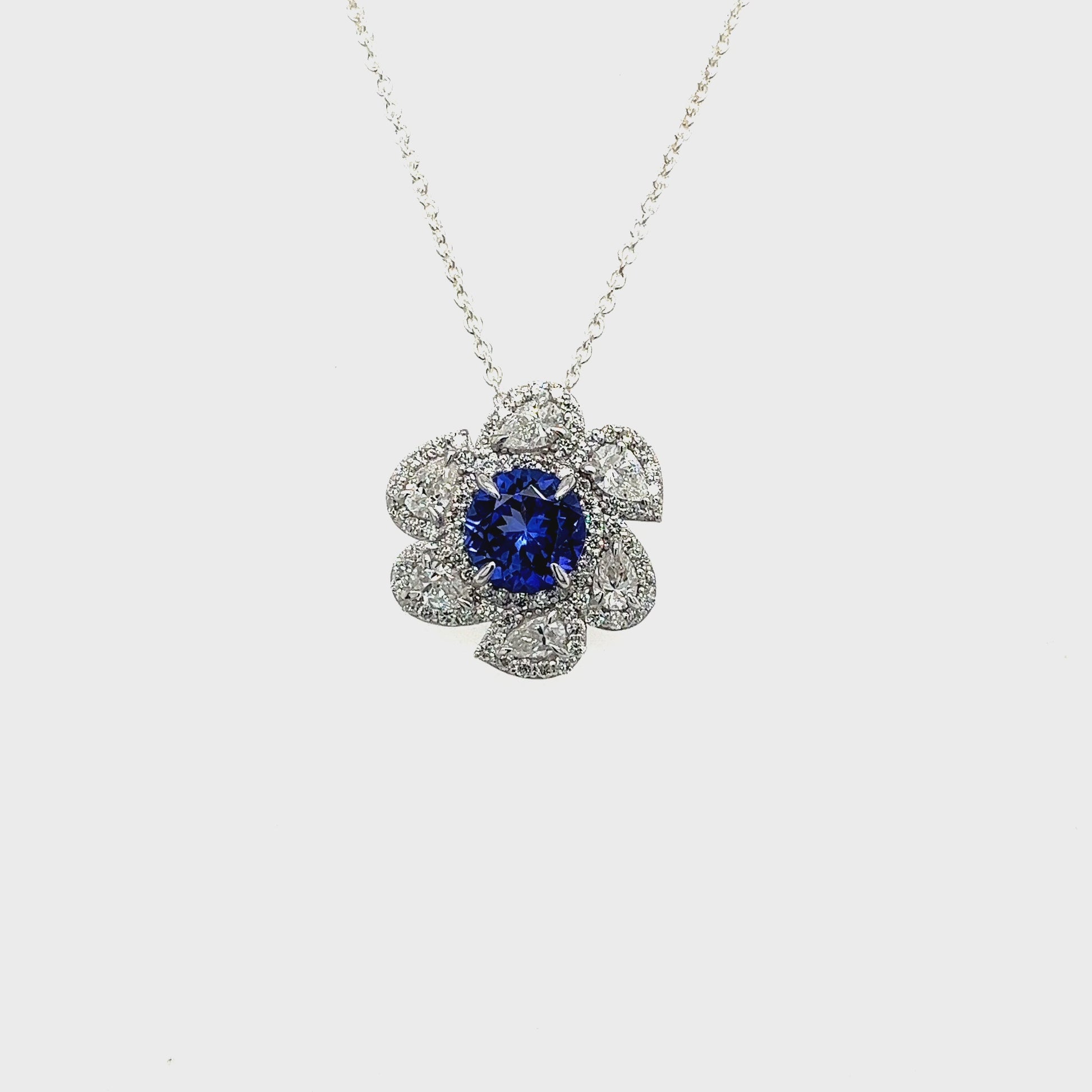 Main Image: "1.70ct Round Tanzanite & Multi-Shape Floral Diamond Pendant" Tanzanite Close-up: "Deep Blue Round Tanzanite Gemstone" Floral Diamond Surround: "Intricate Multi-Shape Diamond Floral Design" Pendant Chain: "Shimmering Chain for Tanzanite and Diamond Pendant" Elegant Neckwear: "Luxurious Tanzanite and Diamond Necklace" Nature-Inspired Elegance: "Floral Diamond Pendant with Round Tanzanite"