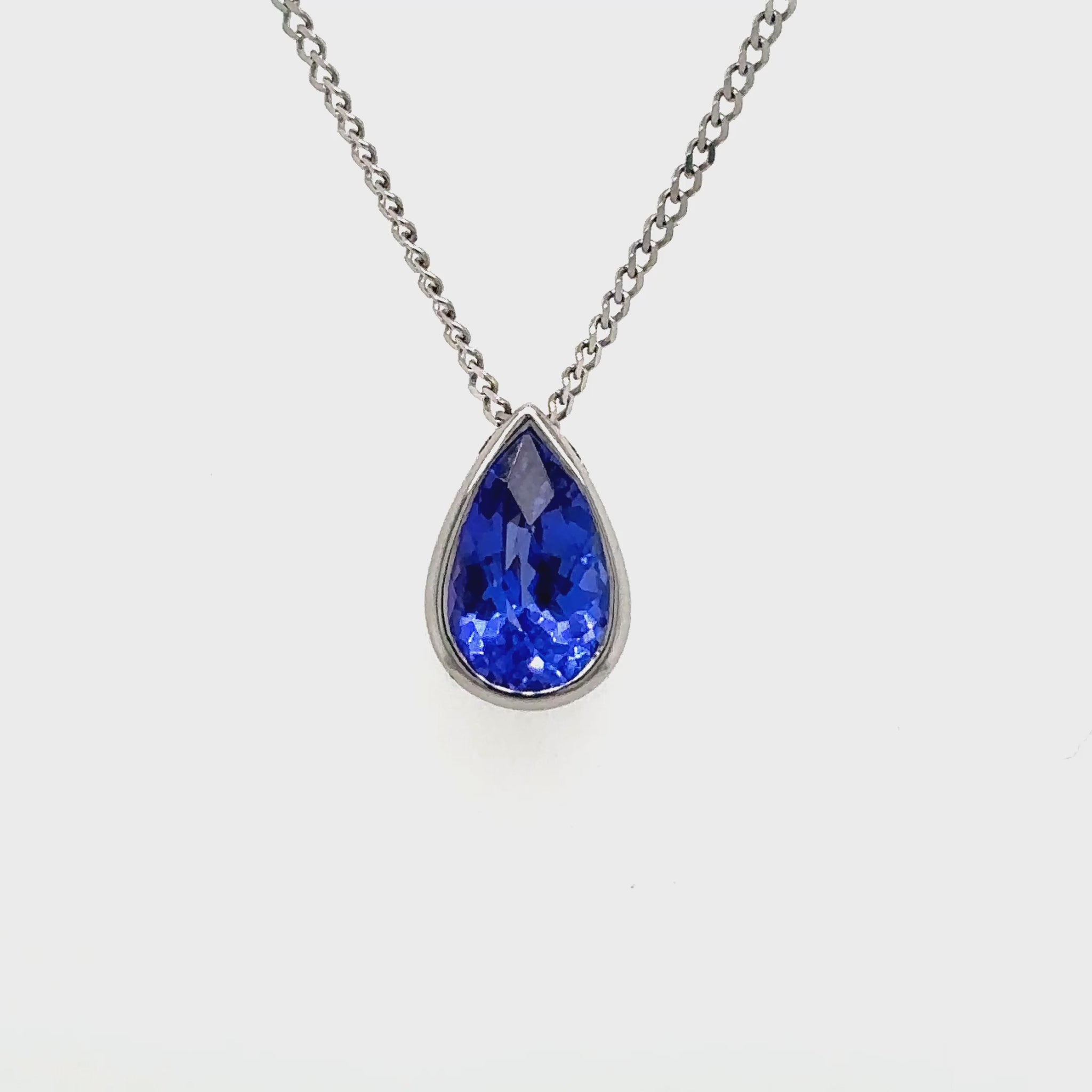 "An exquisite floating pear-shaped tanzanite pendant that exudes elegance and sophistication. Featuring a vibrant pear-cut tanzanite gemstone, this pendant captivates with its rich, deep blue-violet hues. The floating design enhances the gemstone's brilliance, creating a modern yet timeless piece that complements any outfit. Perfect for special occasions or as a thoughtful gift, this pendant showcases the beauty of tanzanite in a sleek and refined setting.