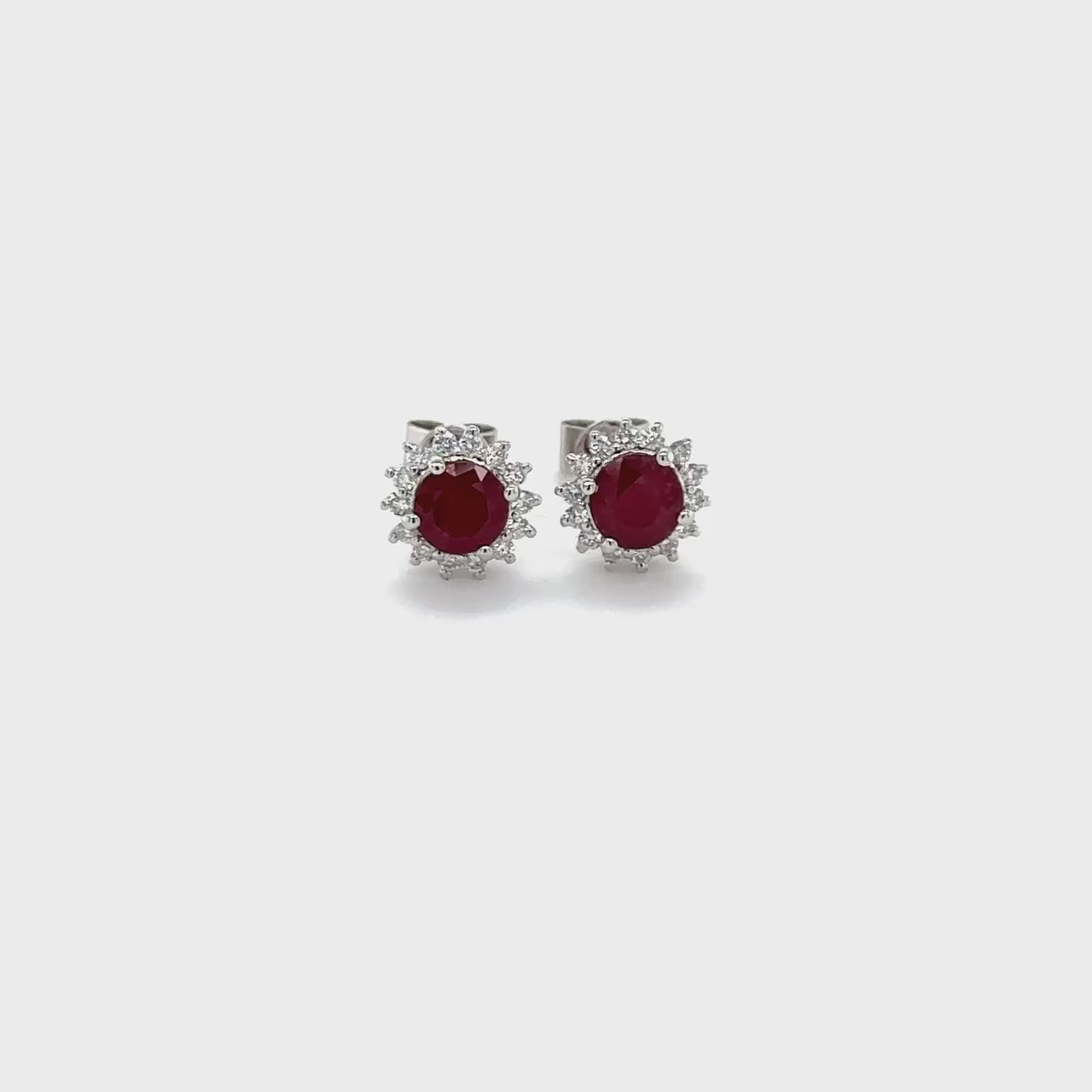 "Round ruby earrings, Diamond stud earrings, Red gemstone jewelry, Elegant jewelry, Fine jewelry, Luxury earrings, Statement earrings, Fashion accessories, Precious gemstone earrings, Sparkling diamond studs"