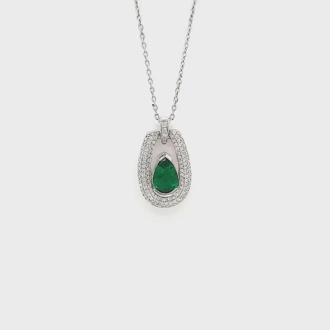 A stunning, pear-shaped emerald pendant, exquisite diamond detailing, elegant jewelry piece, floating design, luxurious emerald and diamond combination, eye-catching gemstone pendant, sophisticated jewelry accessory, radiant pear-cut emerald, sparkling diamond accents, timeless and chic pendant.