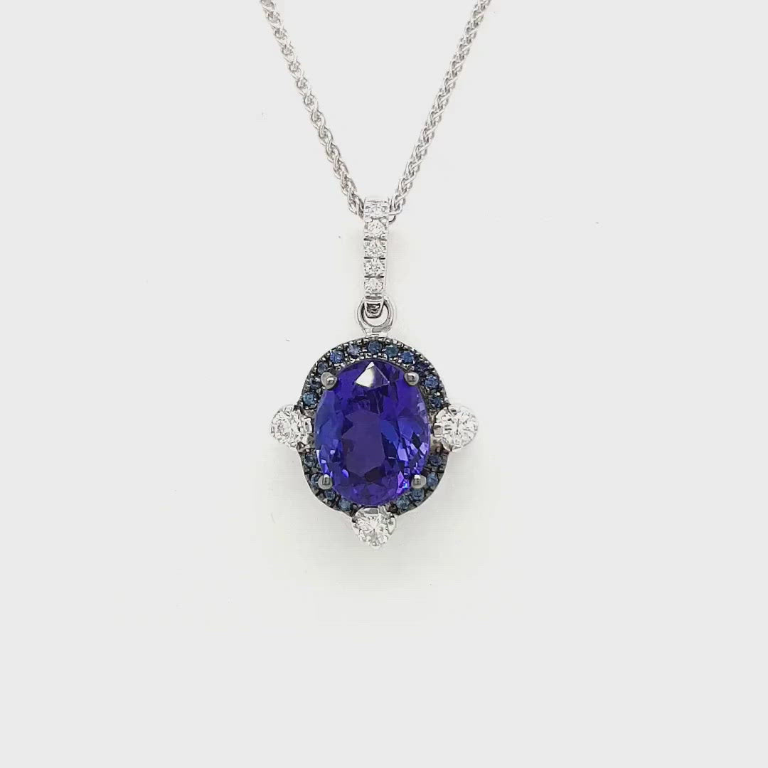 A stunning Oval Tanzanite pendant surrounded by a dazzling halo of diamonds. The rich, violet hues of the Tanzanite gemstone are accentuated by the sparkling brilliance of the surrounding diamonds. This elegant pendant is a timeless piece that effortlessly combines the allure of the oval-shaped Tanzanite with the glamour of a diamond halo. Perfect for adding a touch of sophistication to any ensemble.