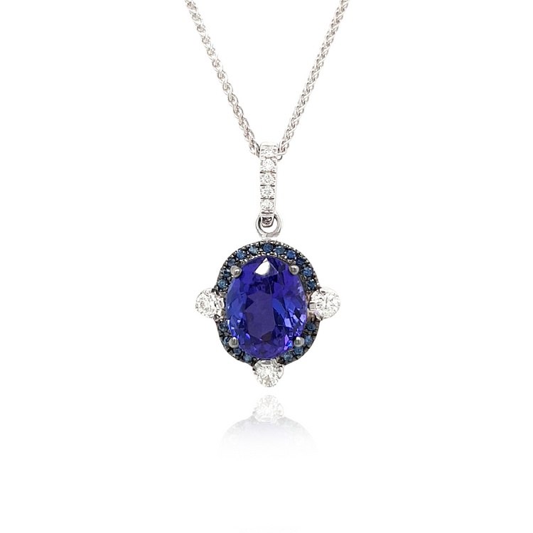 A stunning Oval Tanzanite pendant surrounded by a dazzling halo of diamonds. The rich, violet hues of the Tanzanite gemstone are accentuated by the sparkling brilliance of the surrounding diamonds. This elegant pendant is a timeless piece that effortlessly combines the allure of the oval-shaped Tanzanite with the glamour of a diamond halo. Perfect for adding a touch of sophistication to any ensemble.